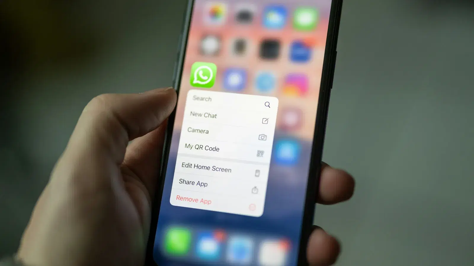 Hand holding an Android phone used to message opted-in customers at scale