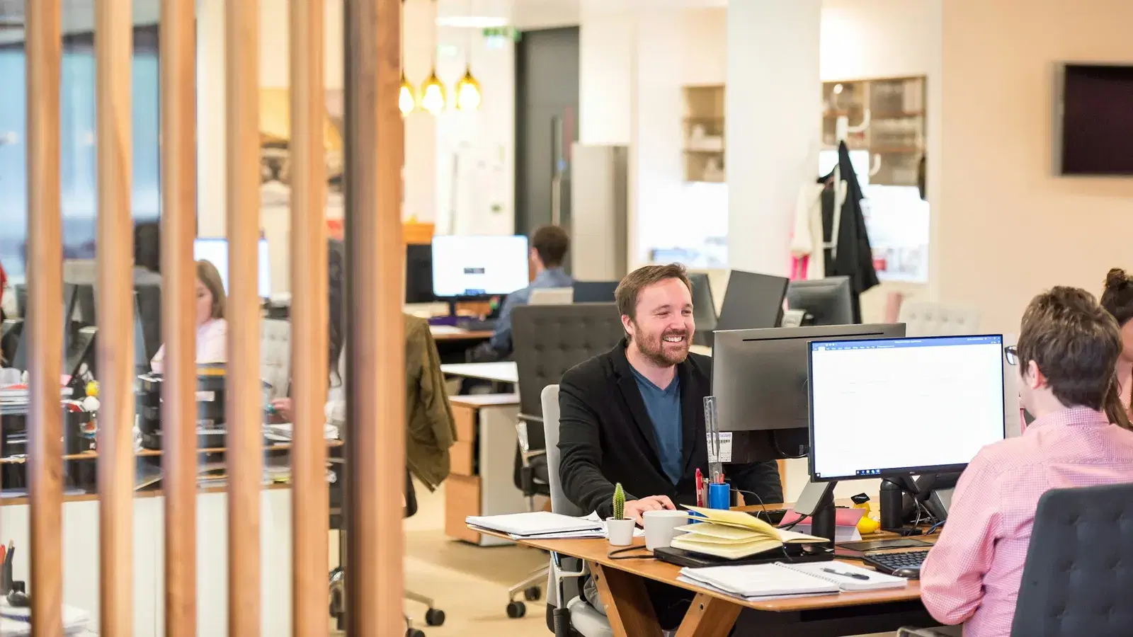 Sales professional at an open plan desk working through qualified leads